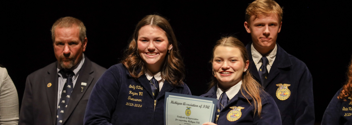 Student being recognized for serving on the nominating committee