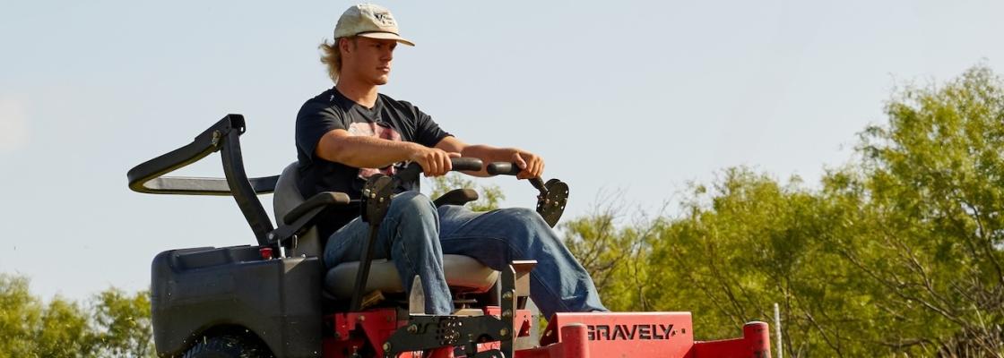 Student driving zero turn mower