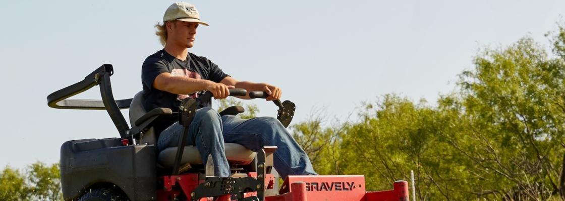 Student driving zero turn mower