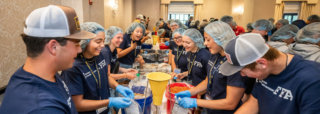 Students packing meals for service project