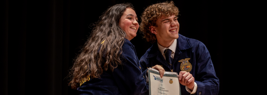 Student receiving Academic Excellence award on stage