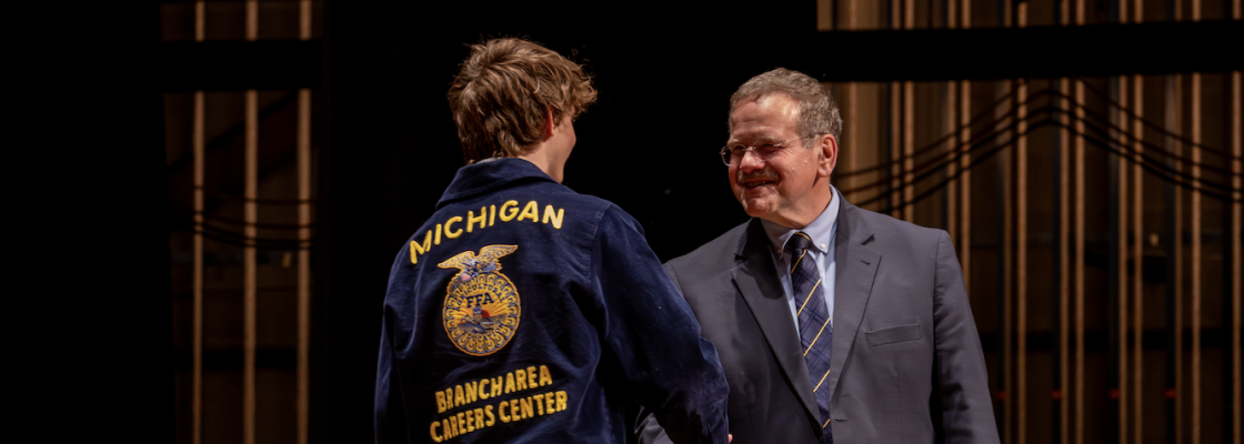 Student receiving scholarship on stage
