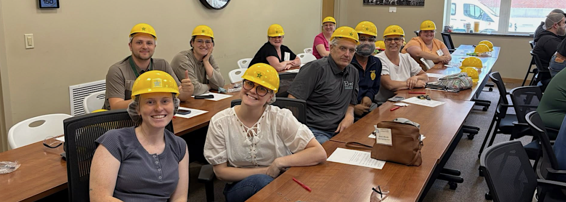 Teachers in hard hats preparing for an industry tour