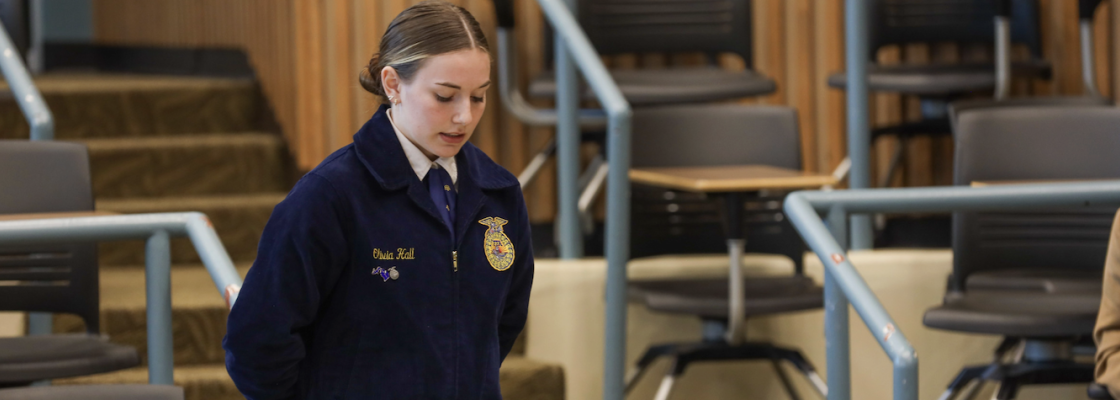 Student competing in parliamentary procedure contest running a meeting